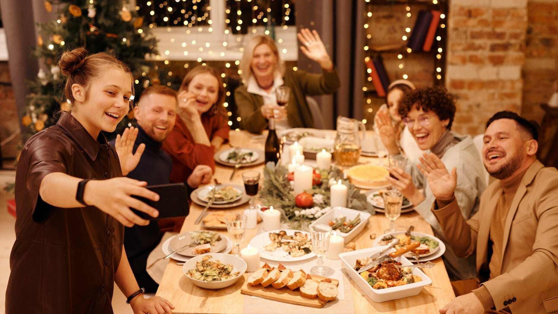 family celebrating christmas dinner while taking selfie
