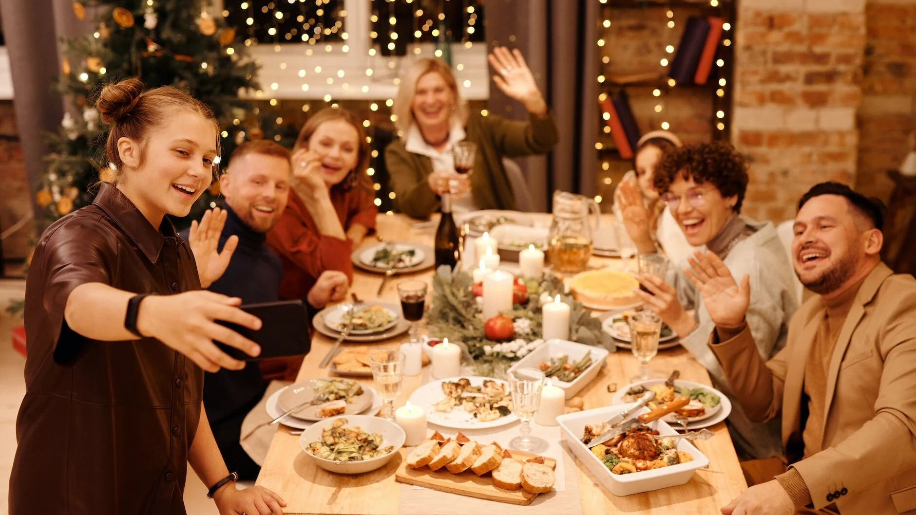family celebrating christmas dinner while taking selfie