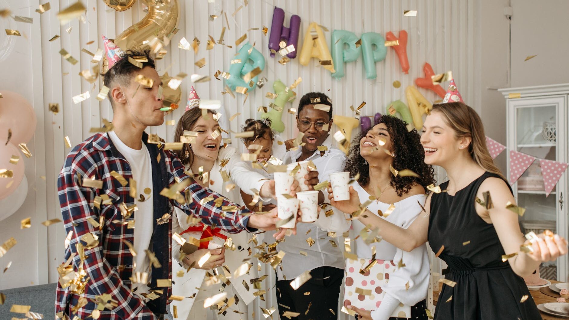 family and group of friends celebrating a child s birthday