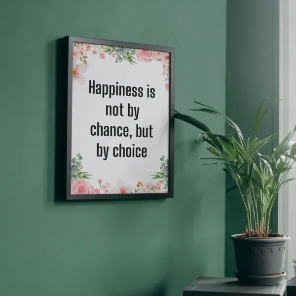 Framed wall art with motivational quote about happiness being a choice, decorated with watercolor floral elements, on a green wall next to a potted plant
