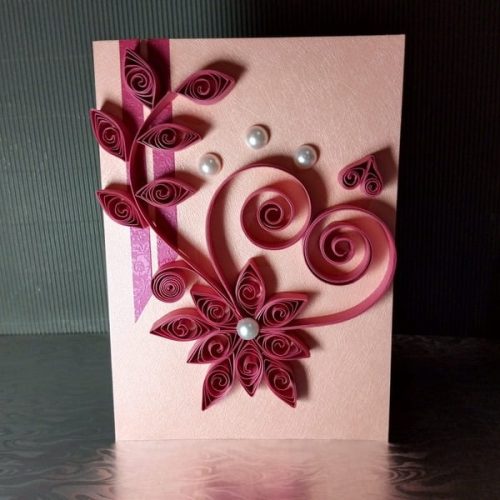 Handmade card for her featuring pink quilled paper art in the shape of a heart with floral elements and pearl embellishments